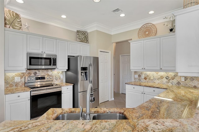 kitchen featuring stainless steel appliances, white cabinets, and sink