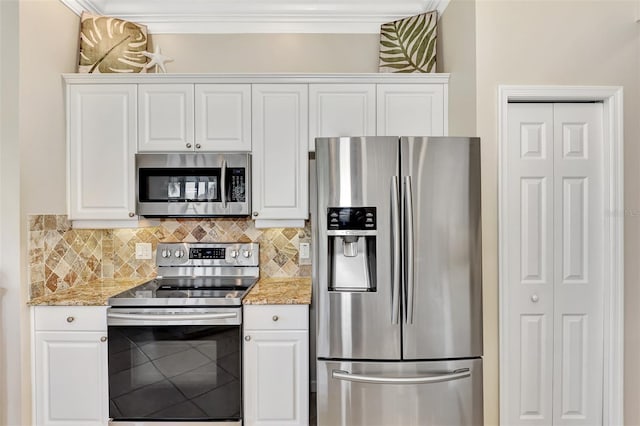 kitchen featuring white cabinets, light stone counters, crown molding, and stainless steel appliances