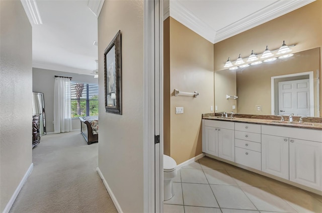 bathroom with crown molding, vanity, tile patterned flooring, toilet, and ceiling fan