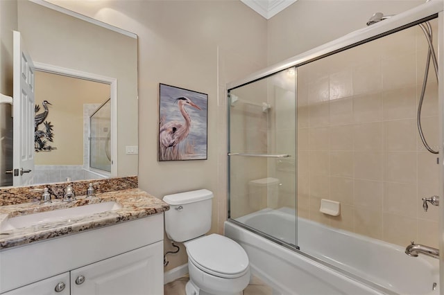 full bathroom with toilet, vanity, bath / shower combo with glass door, and ornamental molding