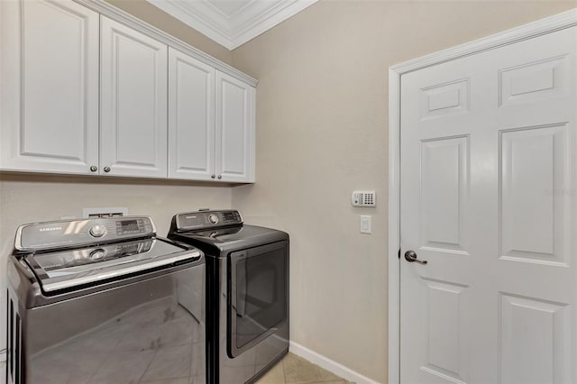 washroom featuring light tile patterned flooring, cabinets, independent washer and dryer, and ornamental molding