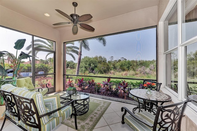 sunroom / solarium featuring ceiling fan