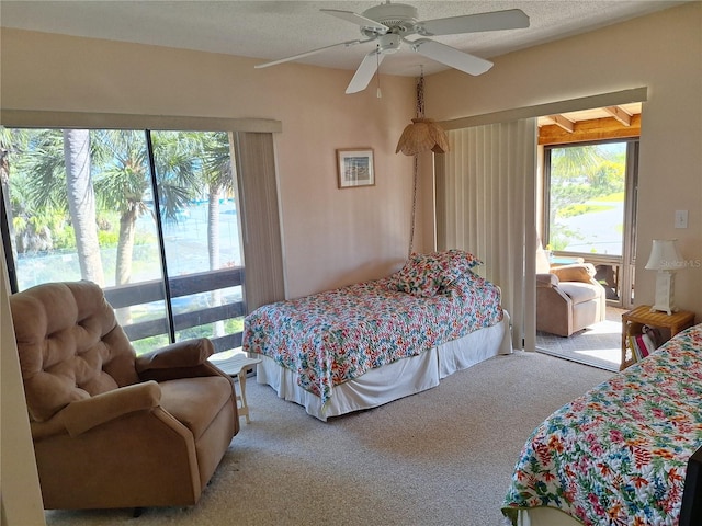 carpeted bedroom featuring a textured ceiling and ceiling fan