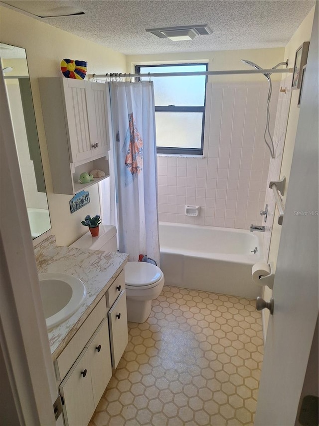 full bathroom with vanity, a textured ceiling, shower / tub combo with curtain, and toilet