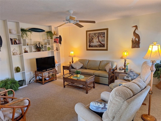 living room featuring ceiling fan, carpet, and a textured ceiling