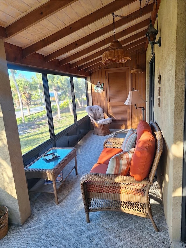 sunroom / solarium featuring vaulted ceiling with beams and plenty of natural light