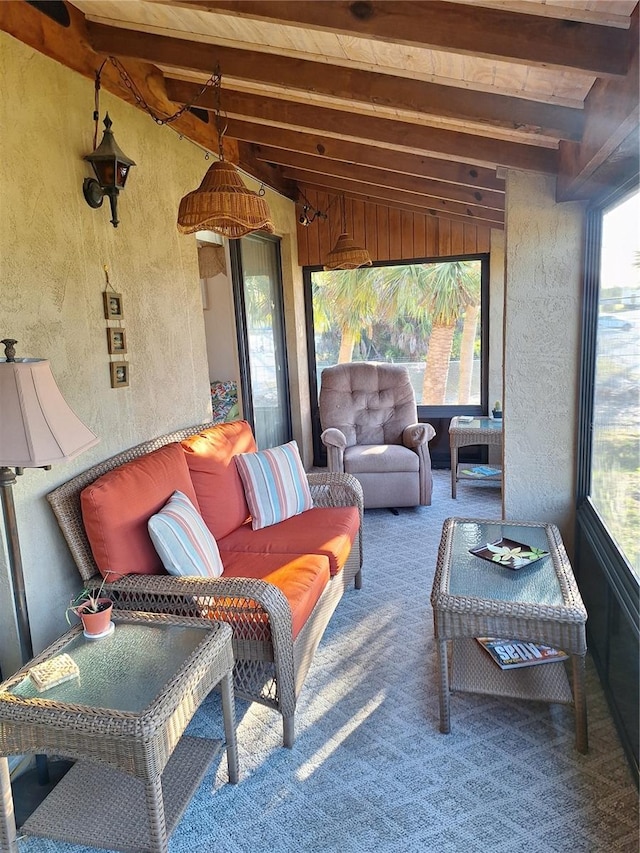 sunroom with lofted ceiling with beams