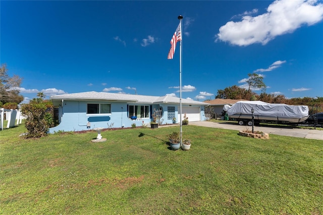 view of front of property featuring a front lawn and a garage