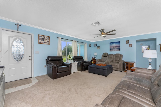 carpeted living room featuring ceiling fan, crown molding, and a textured ceiling