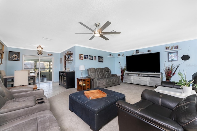 living room featuring ornamental molding, light tile patterned floors, and ceiling fan