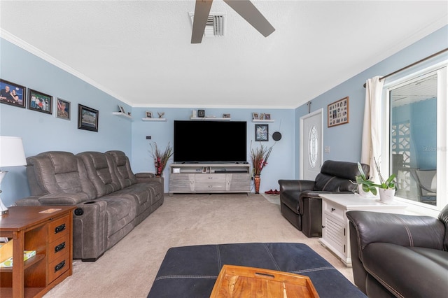 carpeted living room featuring ornamental molding, a textured ceiling, and ceiling fan