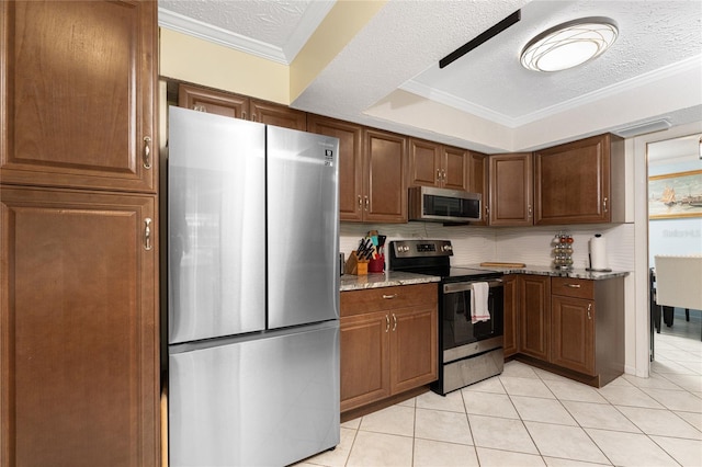 kitchen with backsplash, a textured ceiling, stone counters, crown molding, and stainless steel appliances