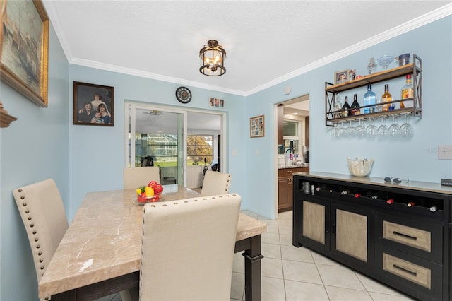 dining area featuring crown molding, a textured ceiling, and light tile patterned floors