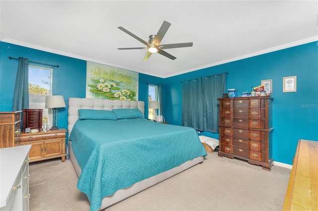 bedroom featuring crown molding, light carpet, and ceiling fan