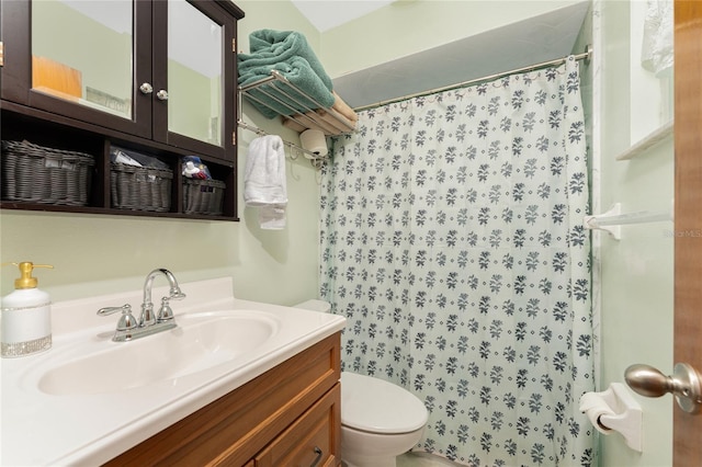 bathroom featuring toilet, curtained shower, and vanity