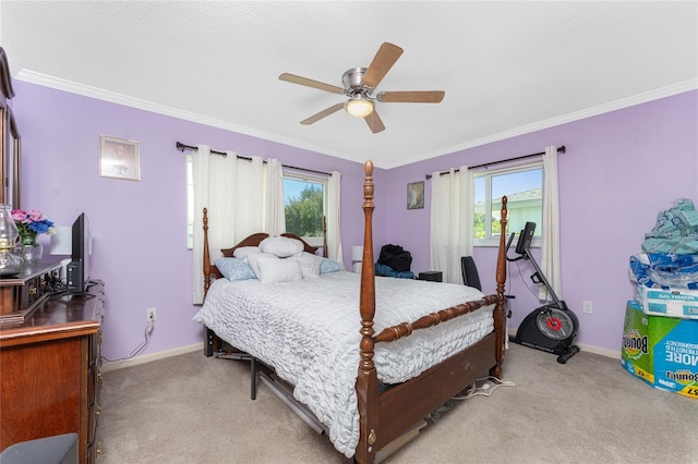 bedroom featuring ceiling fan, ornamental molding, multiple windows, and light colored carpet