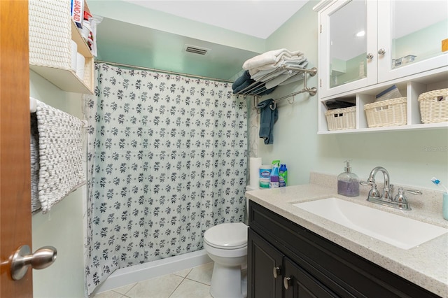 bathroom with toilet, a shower with curtain, vanity, and tile patterned floors