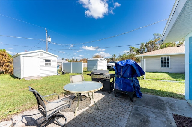 view of patio with a storage shed and a grill