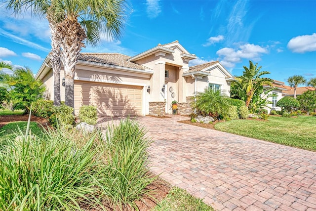 mediterranean / spanish house featuring a front lawn and a garage