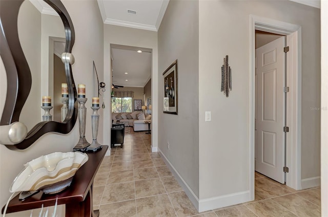 corridor featuring crown molding and light tile patterned flooring