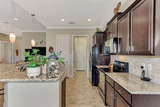 kitchen with dark brown cabinets, tasteful backsplash, black appliances, and hanging light fixtures