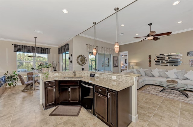 kitchen featuring dark brown cabinetry, stainless steel dishwasher, and hanging light fixtures