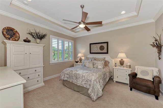 carpeted bedroom featuring crown molding, a raised ceiling, and ceiling fan