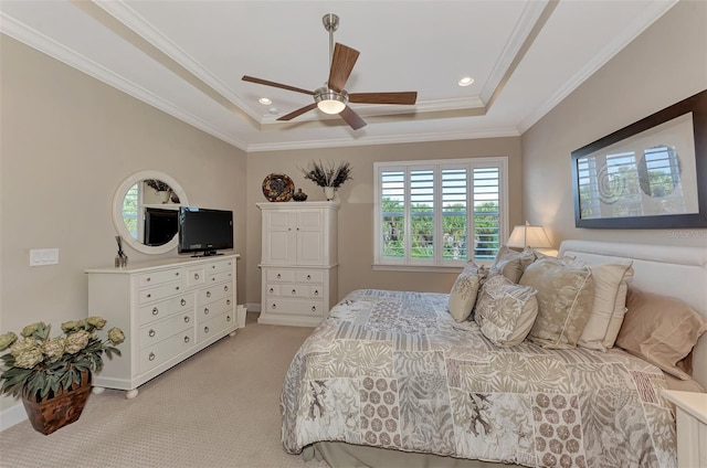 bedroom featuring crown molding, light carpet, a tray ceiling, and ceiling fan