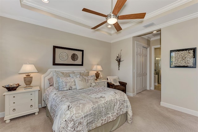 bedroom featuring light carpet, ceiling fan, a tray ceiling, crown molding, and a closet