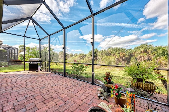 view of patio featuring area for grilling and a lanai