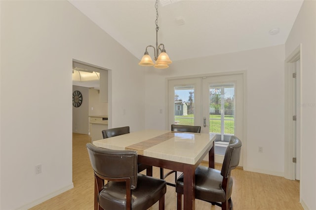 dining room featuring light hardwood / wood-style floors, a notable chandelier, and lofted ceiling