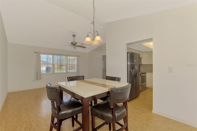 dining space featuring light hardwood / wood-style floors, lofted ceiling, and ceiling fan with notable chandelier