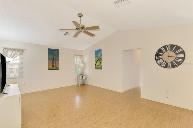 interior space featuring light hardwood / wood-style floors, lofted ceiling, plenty of natural light, and ceiling fan