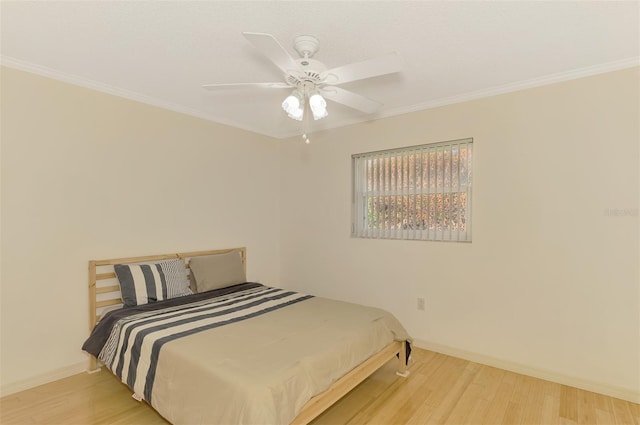 bedroom with light hardwood / wood-style floors, ornamental molding, and ceiling fan