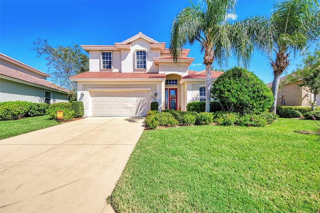 mediterranean / spanish house featuring a front lawn and a garage