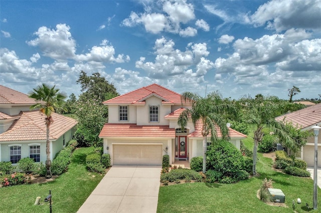 mediterranean / spanish-style home featuring a garage and a front lawn