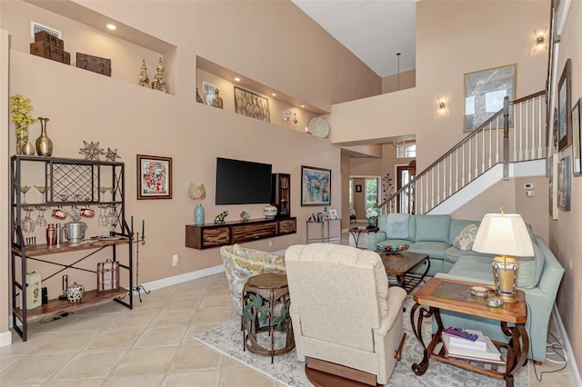 living room featuring a towering ceiling and light tile patterned floors