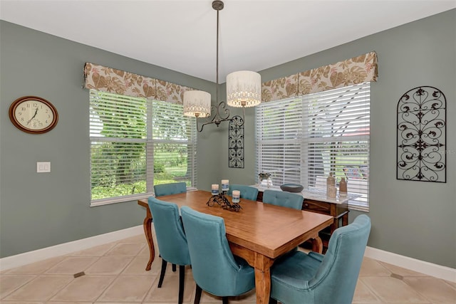 tiled dining room featuring a notable chandelier