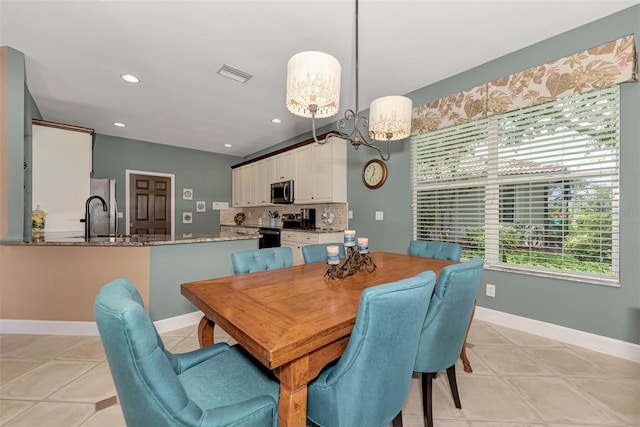 tiled dining room with sink