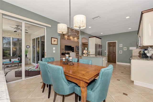 tiled dining room featuring ceiling fan