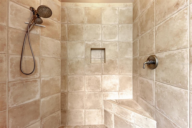 bathroom with tiled shower