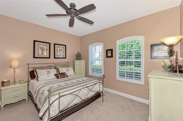 bedroom featuring ceiling fan and light carpet