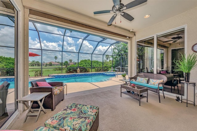 view of pool with a patio, an outdoor hangout area, ceiling fan, and glass enclosure