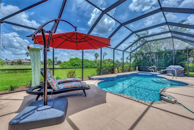 view of swimming pool with a yard, a patio area, and a lanai