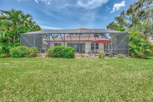 back of property featuring a yard and a lanai