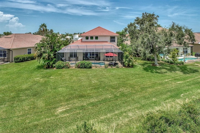 back of property featuring a patio, a lawn, and glass enclosure