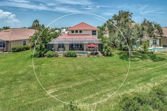 exterior space featuring a patio, a lawn, and glass enclosure