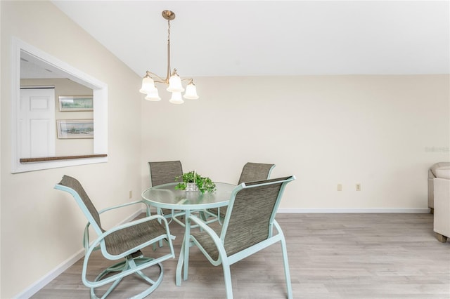 dining area featuring an inviting chandelier and light wood-type flooring