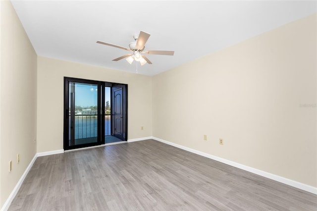 spare room featuring ceiling fan and light hardwood / wood-style flooring