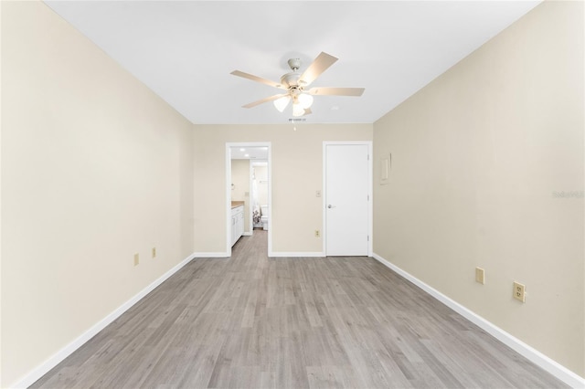 unfurnished bedroom featuring light hardwood / wood-style flooring, connected bathroom, and ceiling fan